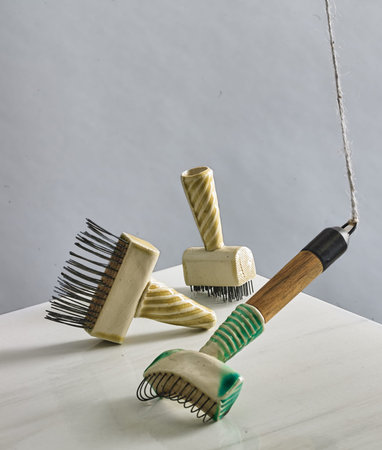 Wooden hairbrush and comb on a white table