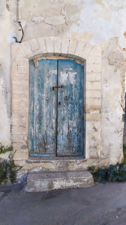 Traditional very old painted door in a historical district or medina, Tunisia. Colorful textured image of muslim architecture.の写真素材