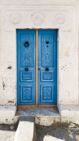 Traditional old painted door in a historical district or medina, Tunisia. Colorful textured image of muslim architecture.の写真素材