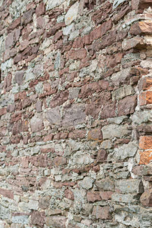 red stone wall. fragment of an ancient castleの写真素材