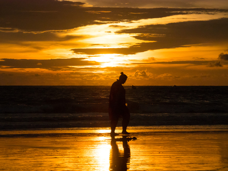 Woman Walking on the Beach When Sunset. Sunset in Langkawi Island, Malaysia.の写真素材