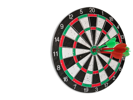 Isolated Dart Board with Holes on the Dart Board Due to Throwing Darts Multiple Times. Four Darts Hit the Red Bullseyeの写真素材