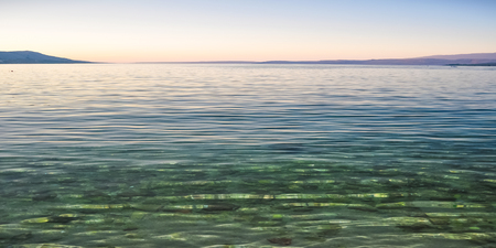 Beach in the coast of Adriatic Sea island Pag, Croatia after sunsetの写真素材