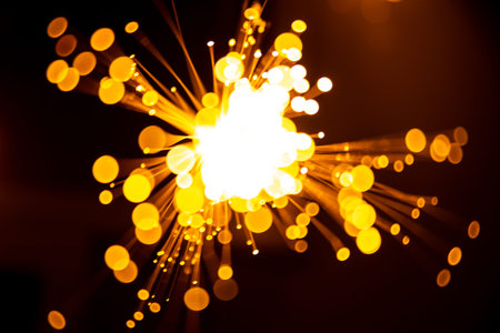 Fiber optic light abstract bokeh background with warm color. Out of focus. Blank white space at the...