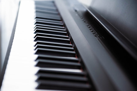 Close-up of electric piano keys, shallow depth of field. Music industry. Copy space