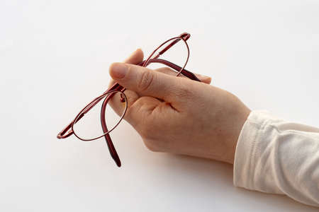 holding pair of glassesの写真素材