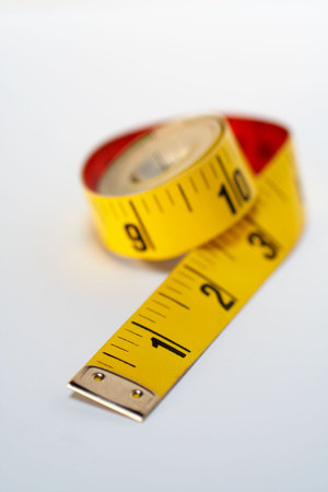 Yellow tape measure macro, isolated on white background