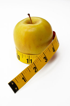 Yellow Apple with tape measureの写真素材