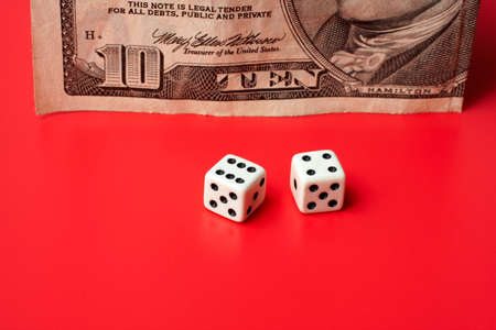 ten dollar and dices, on a red backgroundの写真素材