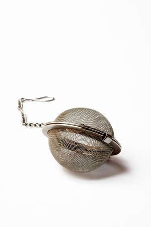 Stainless steel tea ball on white backgroundの写真素材