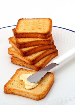 Toast with butter on white plate
