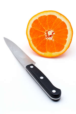 Knife and Half an orange on white backgroundの写真素材
