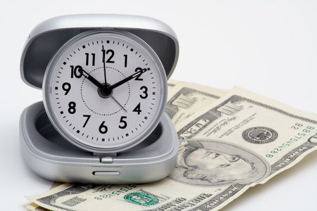 Clock and money (dollars), isolated on white background