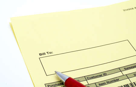 Close up Blank invoice with pen on white backgroundの写真素材