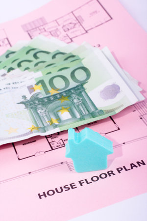 House and money on home plan background