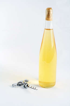Corkscrew and bottle of wine on a white backgroundの写真素材