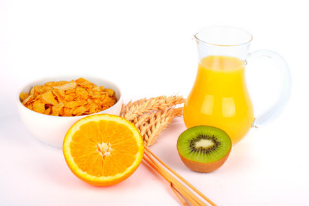 Orange juice and cereals bowl with half kiwi on white background