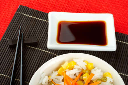 Salad of rice with sauce and sticks on bamboo matの写真素材