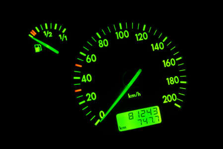 The green neon speedometer over a black backgroundの写真素材
