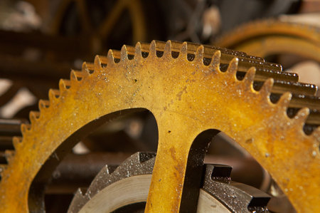 An old and dirty industrial gears background. Shallow DOF