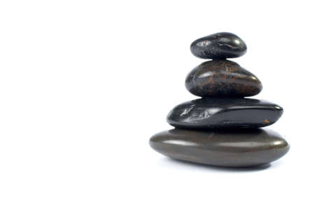 Stack of balanced stones with shadow on white backgroundの写真素材