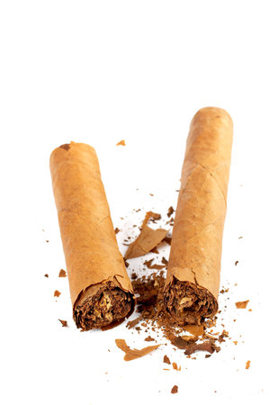 A broken cuban cigar on a white background. Shallow DOF