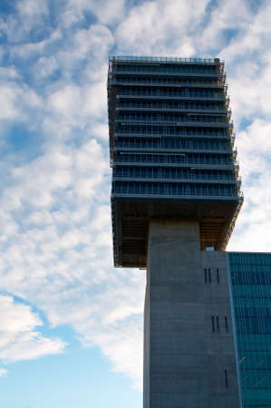 Corporate building over a cloudy blue sky backgroundの写真素材