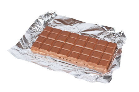 Block of fine chocolate on white background. Shallow DOF