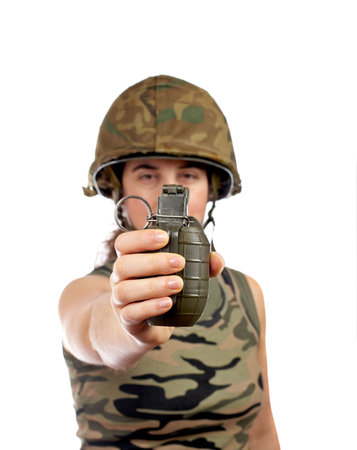 A beautiful soldier girl holding a hand grenade on white background. Focus at front and shallow DOF