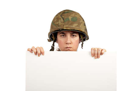 Serious soldier girl holding advertising space on white backgroundの写真素材