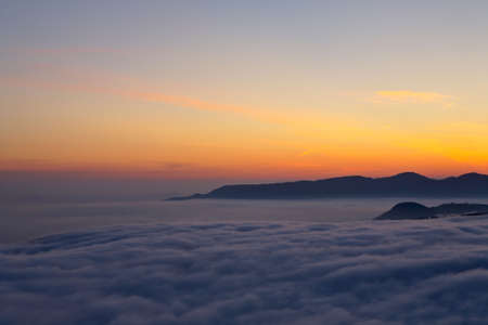 Mountains over the fog in the spring sunriseの写真素材