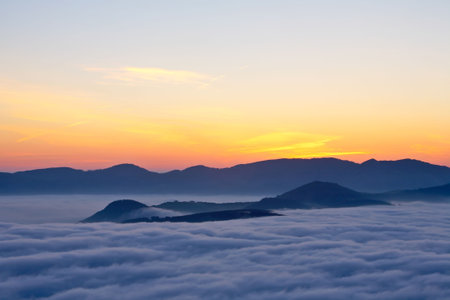 Mountains over the fog in the spring sunriseの写真素材