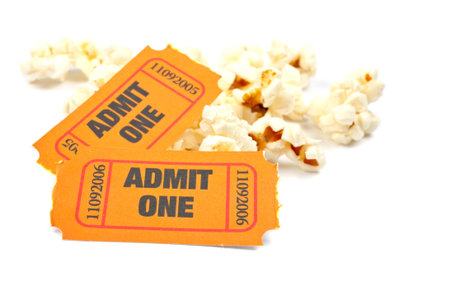 Popcorn and two tickets on white background with soft shadow. Shallow DOF