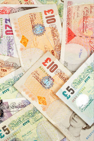 Pounds money background with selective focus at frontの写真素材