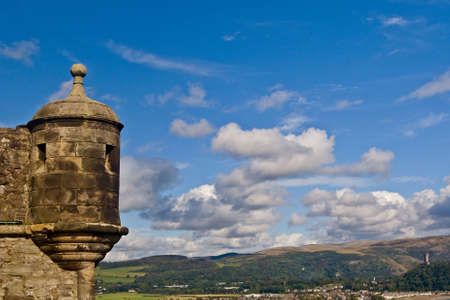 A view of National Wallace Monument and Stirling from the castle, under a cloudy sky, Scotlandの写真素材