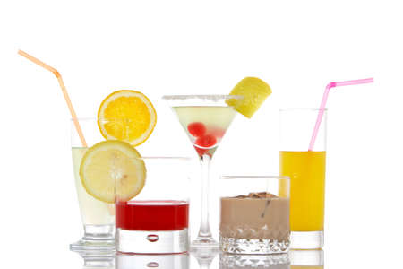 A set of glasses with beverages, reflected on white backgroundの写真素材