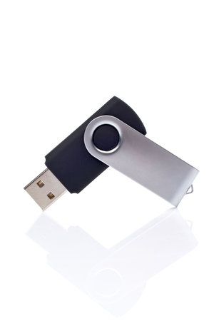 Portable flash usb pen drive memory reflected on white background. Shallow DOF