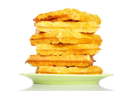 A big stack of waffles on the green plate reflected on white backgroundの写真素材