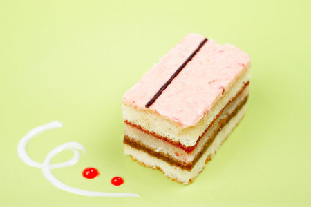 Delicious cake with soft shadow on green dish. Shallow DOF
