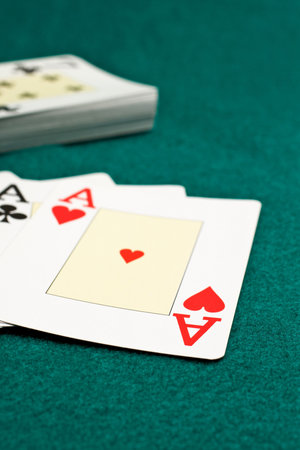 Aces poker on green background. Shallow depth of field