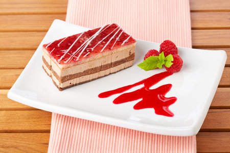 Delicious strawberry cake with soft shadow on white dish. Shallow depth of field