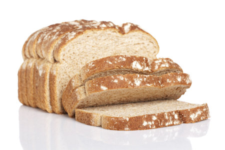 A slices of bread reflected on white background. Shallow depth of field