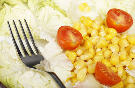Salad with lettuce, tomatoes and corn. Shallow depth of fieldの写真素材