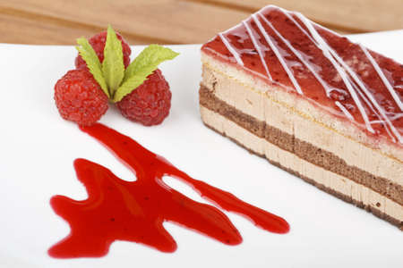 Delicious raspberries cake with soft shadow on white dish. Shallow depth of fieldの写真素材