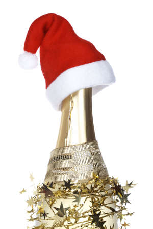 Christmas decoration and champagne bottle with red hat reflected on white background. Shallow depth of fieldの写真素材