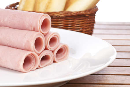 Rolled tasty ham on white dish and bread. Shallow depth of fieldの写真素材