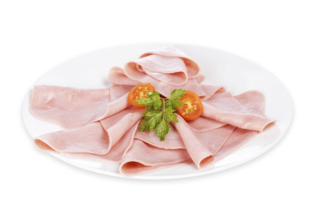 Slices of tasty ham with tomatoes on white dish. Shallow depth of fieldの写真素材