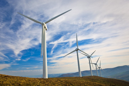 Windmills turning on the sunset in summer. Motion blur