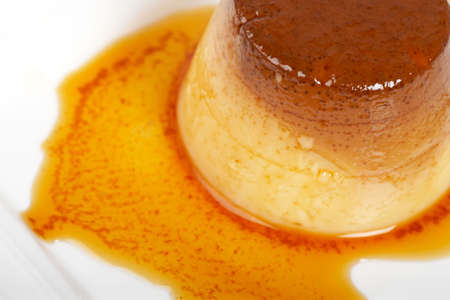 Vanilla cream caramel dessert on white dish. Shallow depth of fieldの写真素材