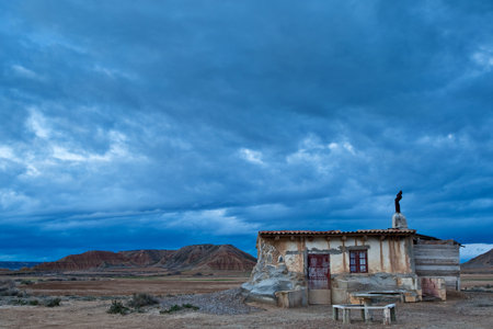 Old shanty under the cloudy sky in spring season